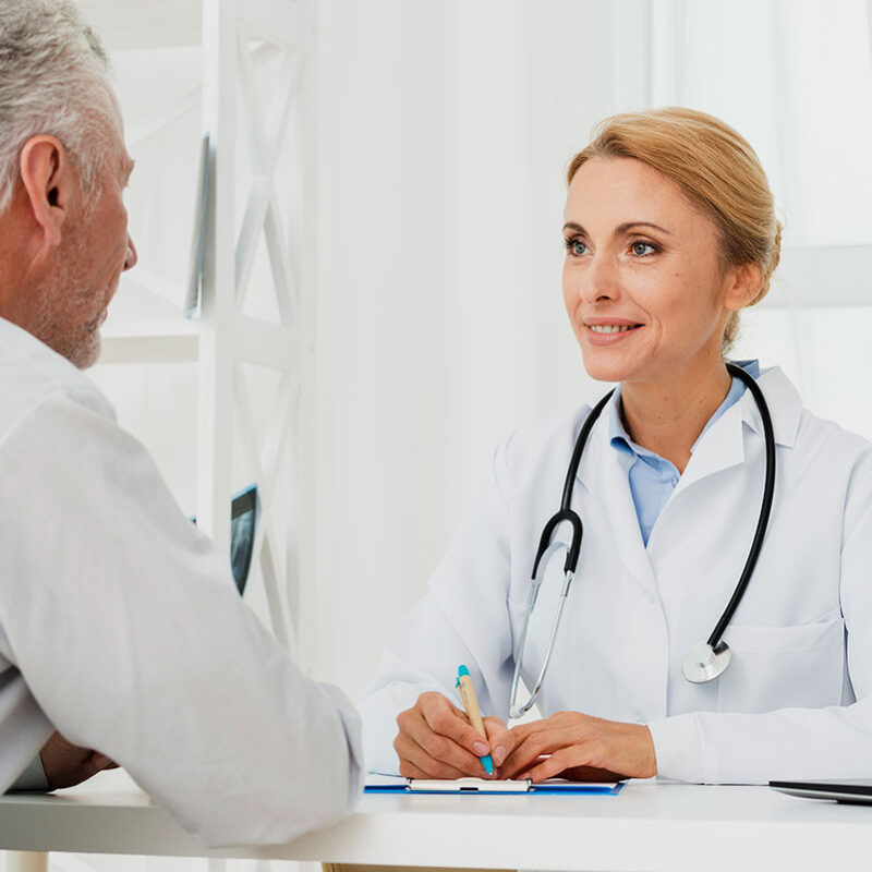 Doctor discussing personalized healthcare options with an older patient during an unhurried visit.