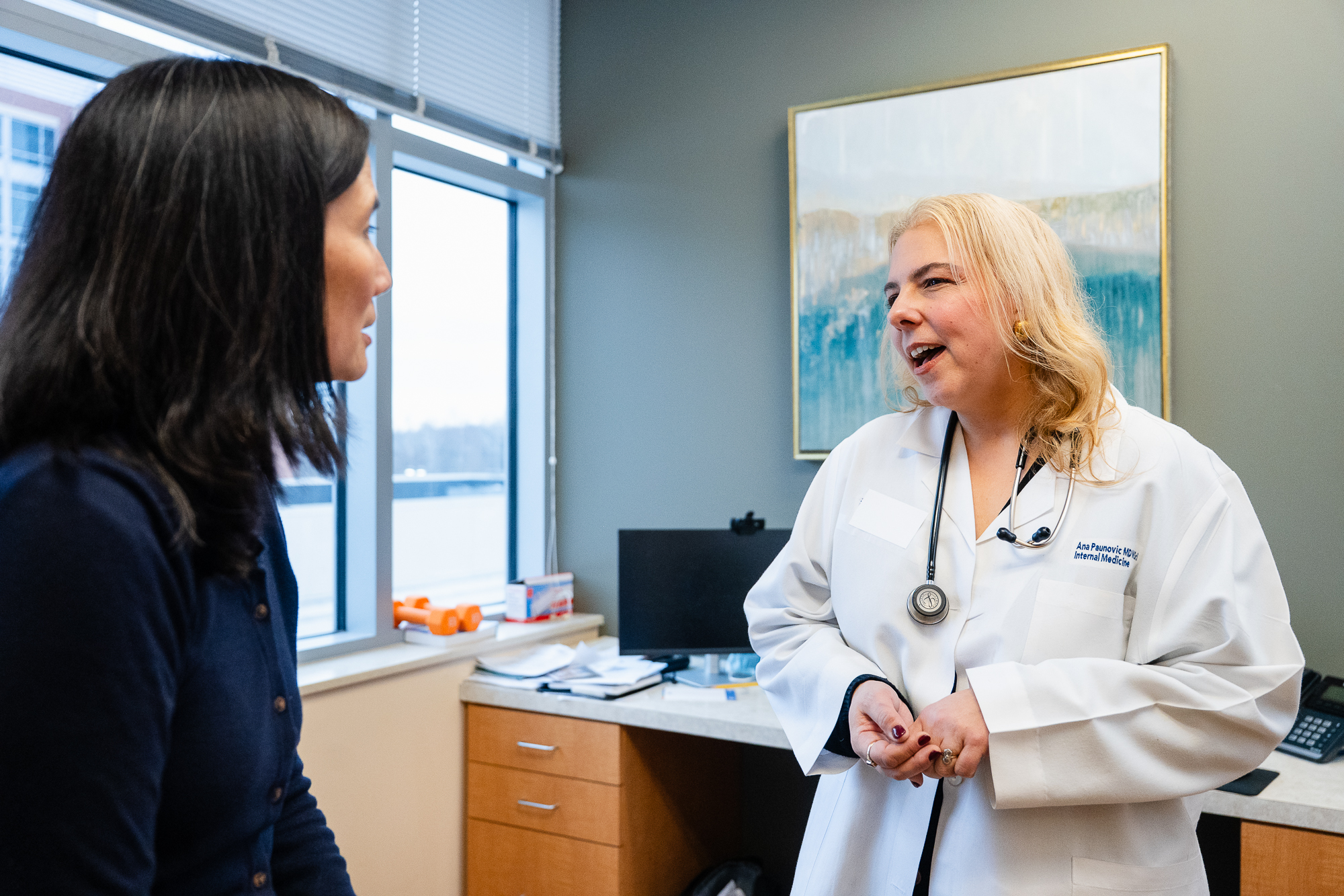 Dr. Ana Paunovic speaking with a patient during a consultation - Complete Concierge Care in Bethesda